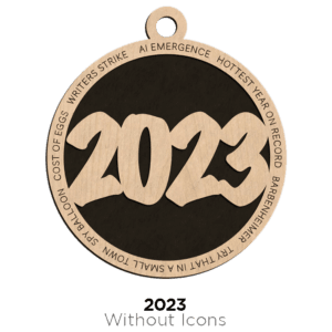 A round ornament with "2023" cut out in the center surrounded by various phrases and DooDads.
